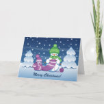 Crafty Snowman Knitting Scarf Holiday Card<br><div class="desc">Vector illustration of two adorable cartoon snowmen dressed in knitted hats and scarves. The big crafty snowman is knitting an oversized scarf for the little one. The scarf is already wrapped several times around the cute little snowman.</div>