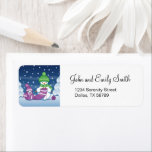 Crafty Snowman Knitting Scarf Label<br><div class="desc">Vector illustration of two adorable cartoon snowmen dressed in knitted hats and scarves. The big crafty snowman is knitting an oversized scarf for the little one. The scarf is already wrapped several times around the cute little snowman.</div>