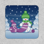Crafty Snowman Knitting Scarf Patch<br><div class="desc">Vector illustration of two adorable cartoon snowmen dressed in knitted hats and scarves. The big crafty snowman is knitting an oversized scarf for the little one. The scarf is already wrapped several times around the cute little snowman.</div>