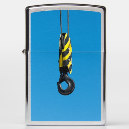 Crane hook with yellow and black stripes hanging zippo lighter