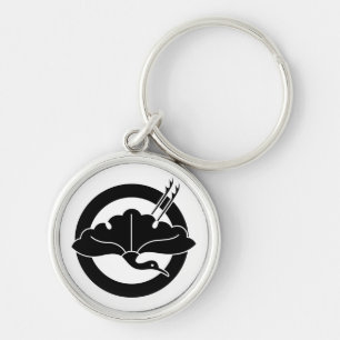 Crane-shaped ginkgo leaf on circle keychain