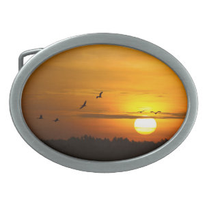 Cranes at sunrise belt buckle