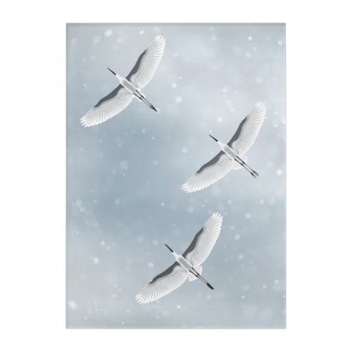 Cranes flying on the winter sky in silent snowfall acrylic print