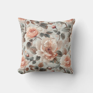 Cream flowers with grey leaves on a light grey throw pillow