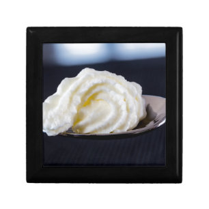 cream on a spoon macro concept gift box