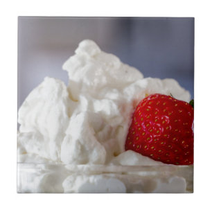 Cream with strawberries in a glass bowl tile