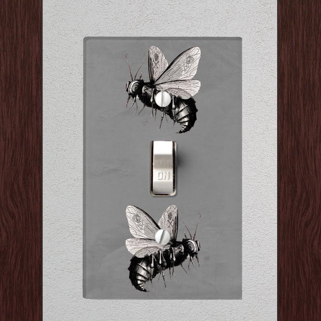 Creepy Gothic Bee Skull Wings Insect Light Switch Cover (Two Gothic black white bees with skull wings on dark grey electrical wall plate.)