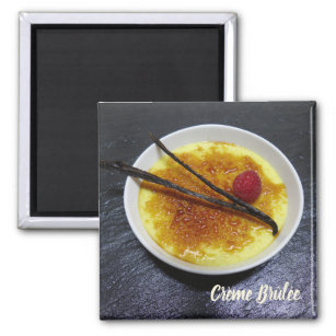 Creme brulee on slate with raspberry and vanilla magnet
