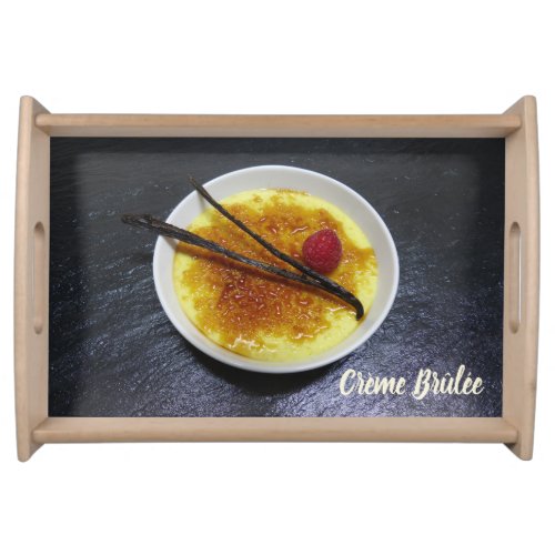 Creme brulee on slate with raspberry and vanilla serving tray