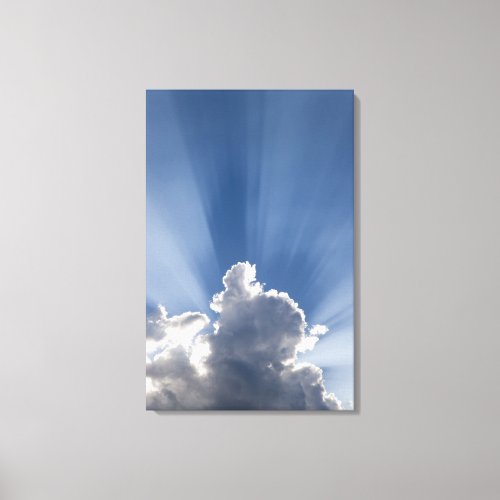 Crepuscular or Gods rays streak past cloud Canvas Print