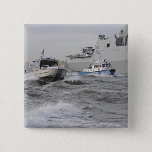 Crews from the coast guard and police departmen pinback button