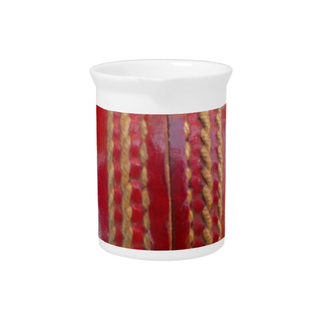 Crimson Stitch Focus: Close-Up of Cricket's Heart Beverage Pitcher (Front)