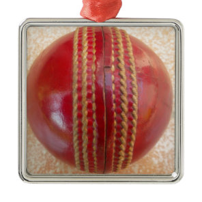 Crimson Stitch Focus: Close-Up of Cricket's Heart Metal Ornament