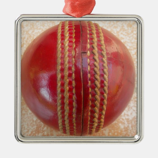 Crimson Stitch Focus: Close-Up of Cricket's Heart Metal Ornament (Front)