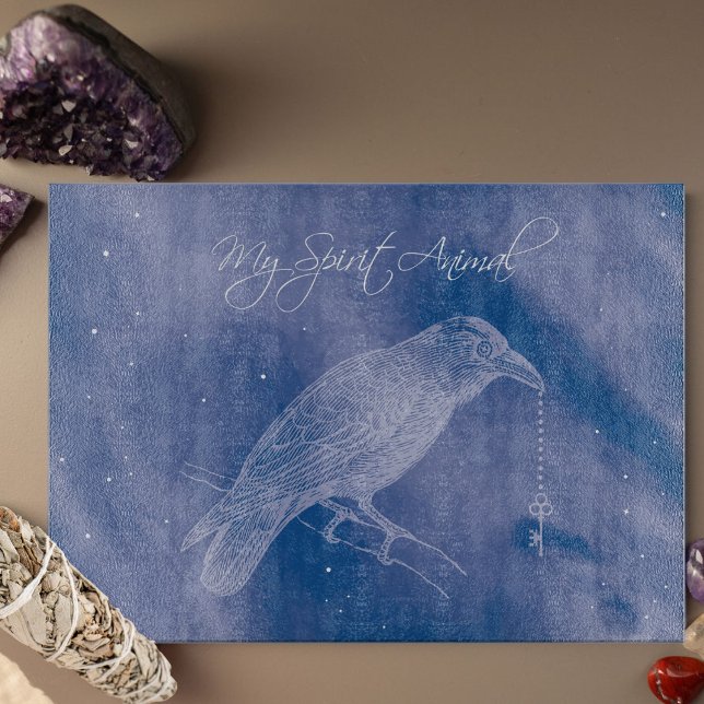 Crow Spirit Animal Cutting Board - Altar Decor (Crow Spirit Animal glass cutting board set against a blue cosmos and holding a skeleton key.)