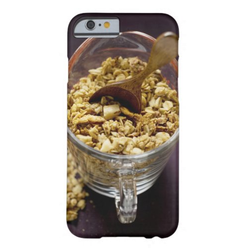 Crunchy muesli with wooden spoon in a measuring barely there iPhone 6 case