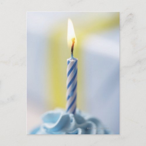 Cupcake with candle close_up focus on flame postcard