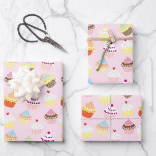 Cupcakes on pink wrapping paper sheets