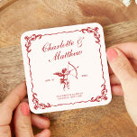 Cupid's Arrow Red Vintage Wedding Square Paper Coaster<br><div class="desc">The Cupid's Arrow suite is a romantic vintage-inspired wedding collection that captures timeless elegance with deep red tones and intricate detailing. Featuring a classic illustration of Cupid with his bow and arrow, delicate ornamental borders, and sophisticated typography, this collection evokes a sense of old-world romance. The design elements blend antique...</div>