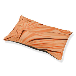 Curlings in tones of orange, curved brown cylinder pet bed