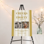 Custom 2 Photo Gold Happy 80th Birthday Foam Board<br><div class="desc">Celebrate a monumental milestone with this custom gold and cream foam board sign for an 80th birthday party! This sign is more than just decor – it's a vibrant tribute to eight decades of an incredible life. Featuring decorative typography that proudly proclaims "Cheers to eighty years, " it instantly sets...</div>