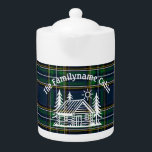 Custom Family Cabin Plaid Ceramic Teapot<br><div class="desc">Serve your favorite tea with rustic charm using this personalized ceramic teapot. Featuring a hand-drawn log cabin nestled between pine trees and a sun motif, this design sits atop a rich green and blue tartan plaid background—perfect for mountain homes, lakeside cabins, or woodland retreats. Add your family name to make...</div>