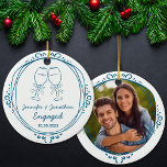 Custom First Christmas Engaged Photo  Ceramic Ornament<br><div class="desc">Celebrate your newly engaged status with this elegant personalized engagement ornament! Featuring two toasting wine glasses tied with ribbon bows and the couple's names and engagement date, it's the perfect keepsake to commemorate your love story. Add a special touch by uploading a photo to the back — perfect for showcasing...</div>