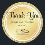 Custom Gold Glitter Thank You Wedding Stickers<br><div class="desc">Gold glitter and gold metallic circles create different visual textures to make a stunning gold thank you sticker. Thank you is written across the top in a pretty and ornate font. The bride and groom names and their wedding date are placed below. Two gold wedding rings complete the wedding seal....</div>