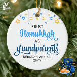 Custom GRANDPARENTS FIRST HANUKKAH  Ceramic Ornament<br><div class="desc">Cute FIRST HANUKKAH as GRANDPARENTS ceramic ornament with CUSTOMIZABLE NAMES & YEAR. Design shows Hanukkah blue handwriting script typography with blue and yellow hanging stars. A beautiful souvenir for grandparents first Hanukkah. Design is repeated on the back. Saba Ve-Savta version available separately.</div>