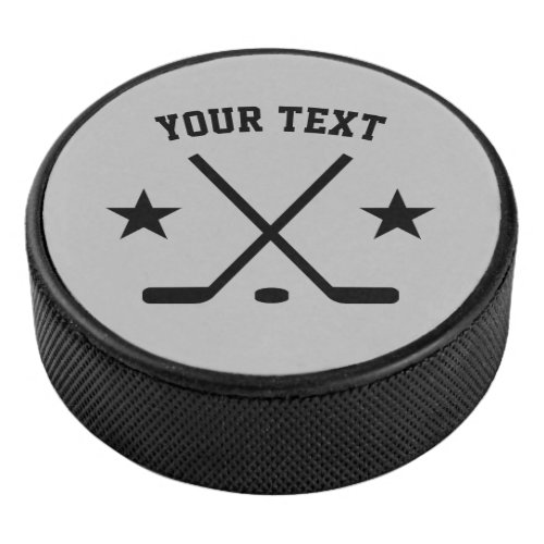 Custom ice hockey puck with crossed sticks logo