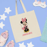 Custom Minnie Mouse | Posing in Pink Tote Bag<br><div class="desc">Add a touch of Disney magic to your everyday essentials with this customizable tote bag featuring Minnie Mouse in her classic pose against a soft pink background. Perfect for Disney fans, this stylish bag allows you to personalize it with your name, combining practicality with Minnie’s timeless charm and playful personality....</div>