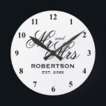 Custom Mr and Mrs newlyweds wedding gift clock<br><div class="desc">Custom Mr and Mrs newlyweds wedding gift clock. Elegant script typography template with family name and date of marriage. Classy presents for just married couple or bride and groom. Chic black and white design home decor. Personalized decor for unique kitchen, office, living room, bedroom etc. Add your own established year...</div>