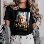 Custom Photo Cheers 80th Birthday Party Tri-Blend Shirt<br><div class="desc">This 80th birthday party t-shirt features the guest of honor's photo with a gold-colored text overlay. The word "cheers" appears in elegant gold-colored calligraphy script, followed by "to 80 years" and the guest of honor's name and birthday in sans serif font. A dark screen helps make the text pop. A...</div>