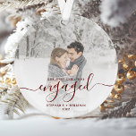 Custom Photo First Christmas Engaged Red Script Ornament<br><div class="desc">Commemorate your engagement with this beautiful modern keepsake ornament. The dark red text reads "Our first Christmas engaged, " with the word "engaged" in elegant handwriting script with flourishes before and after. Replace the sample image with your favorite photo, and add your names and the year. A white gradient filter...</div>