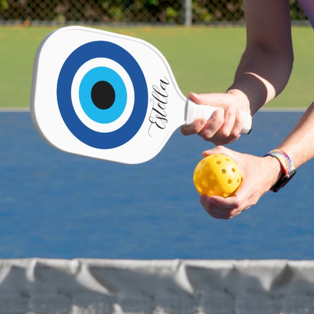 Custom pickleball racket with Evil Eye logo (Insitu)