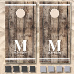 Custom Rustic Family Name Wood Cornhole Set<br><div class="desc">This simple, minimalist cornhole set is a great addition to your family cabin, lake house, or farmhouse. It features a rustic brown driftwood background with clean, understated line details at the top and bottom of each board, offering a timeless, rustic touch. Personalize it with an initial monogram and your family...</div>