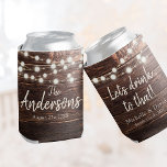 Custom Rustic Wedding Party Favor Barn Wood Lights Can Cooler<br><div class="desc">Rustic Personalized Wedding Favor perfect for the barn or farmhouse wedding: Your custom names,  date,  message and wedding venue in a Modern Script font design with string lights on a dark wood background. We'll drink to that! Makes a great gift for guests.</div>
