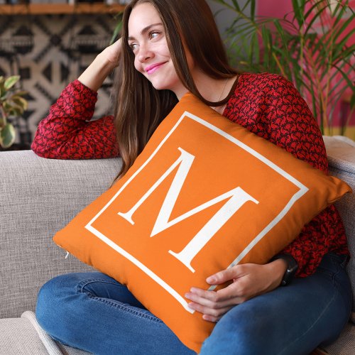 Customize monogram on bright orange throw pillow