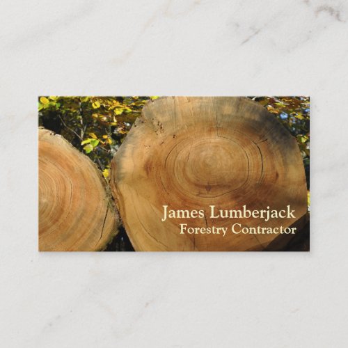 Cut logs in autumn business card