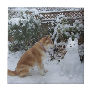 cute akita sitting with snowman in the snow dog ceramic tile
