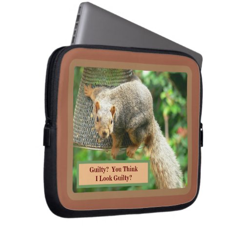 Cute and Guilty_looking Squirrel Swinging On Bird Laptop Sleeve
