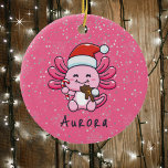 Cute Axolotl with Santa Hat & Candy Cane Christmas Ceramic Ornament<br><div class="desc">Enjoy this cute Christmas design featuring an adorable pink axolotl with a big smile and wearing a Santa Claus hat. It's holding a red and white candy cane and eating a brown gingerbread man cookie. The background is pink with snowy dots and subtle snowflakes. Personalize by adding a name. The...</div>