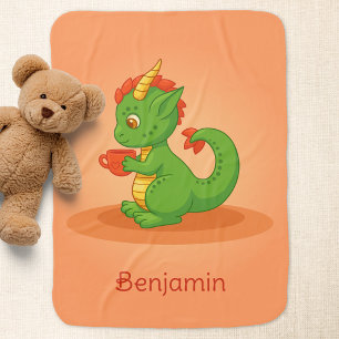 Cute Baby Dragon Holding Cup on Orange Blanket