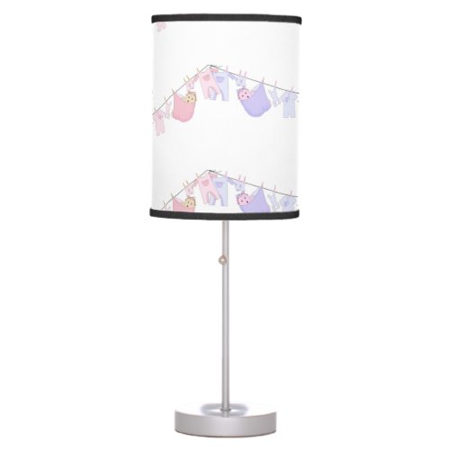 Cute baby hanging on clothing line table lamp