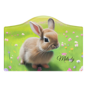 Cute baby rabbit in a flower meadow door sign