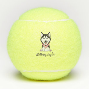 Cute black and white husky dog tennis balls