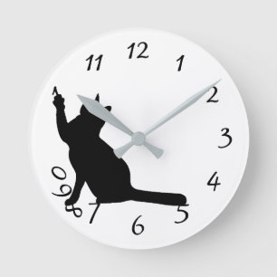 Cute black cat playing with numbers wall clock
