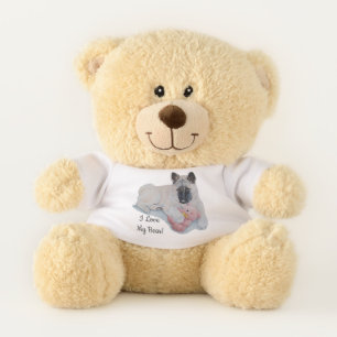 cute black faced akita dog cuddling pink teddy bear