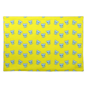 Cute bouncy blue kitten on yellow cloth placemat