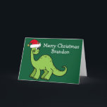Cute Christmas Dinosaur in Santa Hat Custom Green Card<br><div class="desc">Awesome green dinosaur smiling and looking very cute in a holiday red Santa hat. Kids will love this cool green holiday card. Customize these Christmas cards with your own text in white.</div>